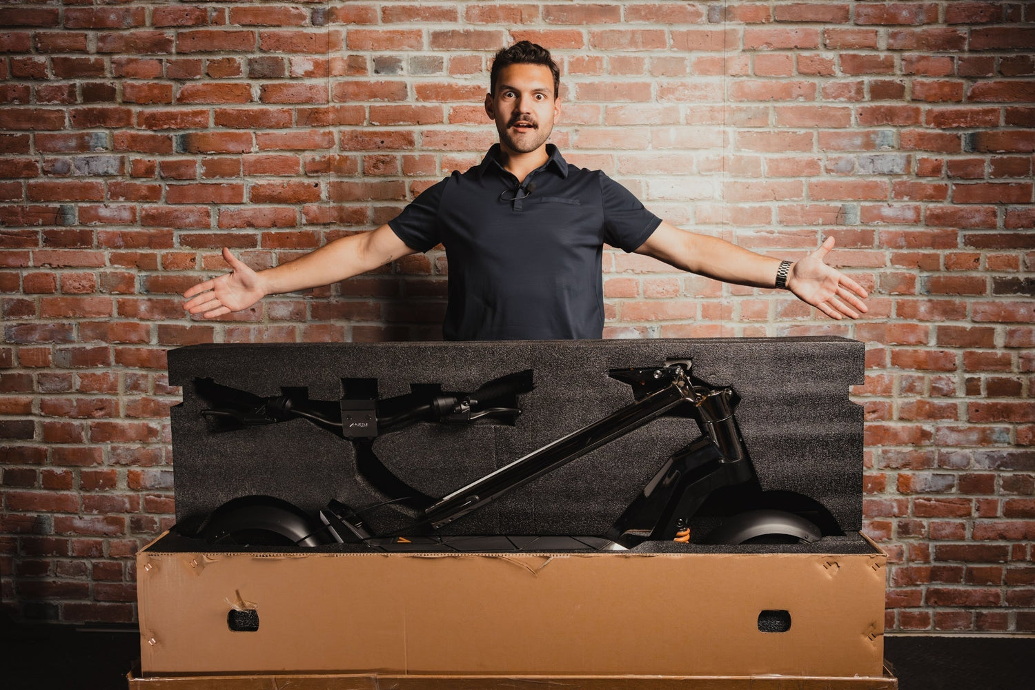 Man with an open Apollo Scooters Box