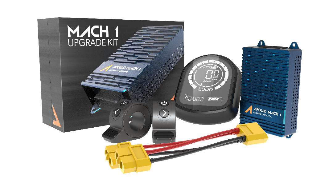 A collection of scooter upgrade kits including components for the Ghost 2023 model, featuring boxes labeled 'MACH 1 UPGRADE KIT', a display unit, and other scooter parts.