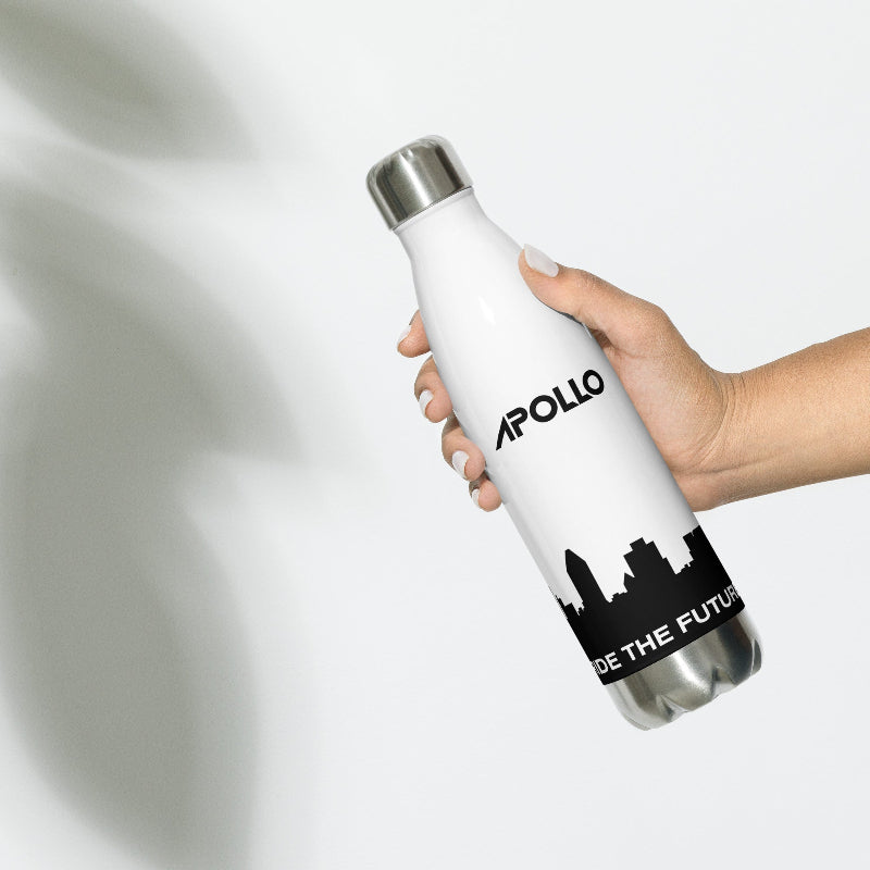 Hand holding a white stainless steel water bottle with the brand name 'Apollo' and the slogan 'BE THE FUTURE' printed on it.