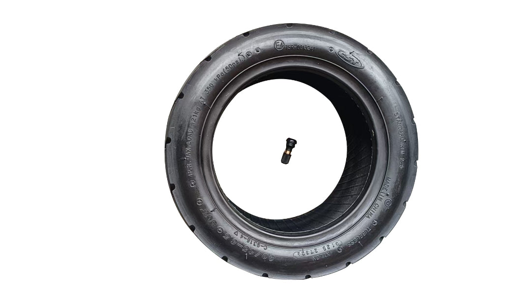 Black tire with valve stem on a white background