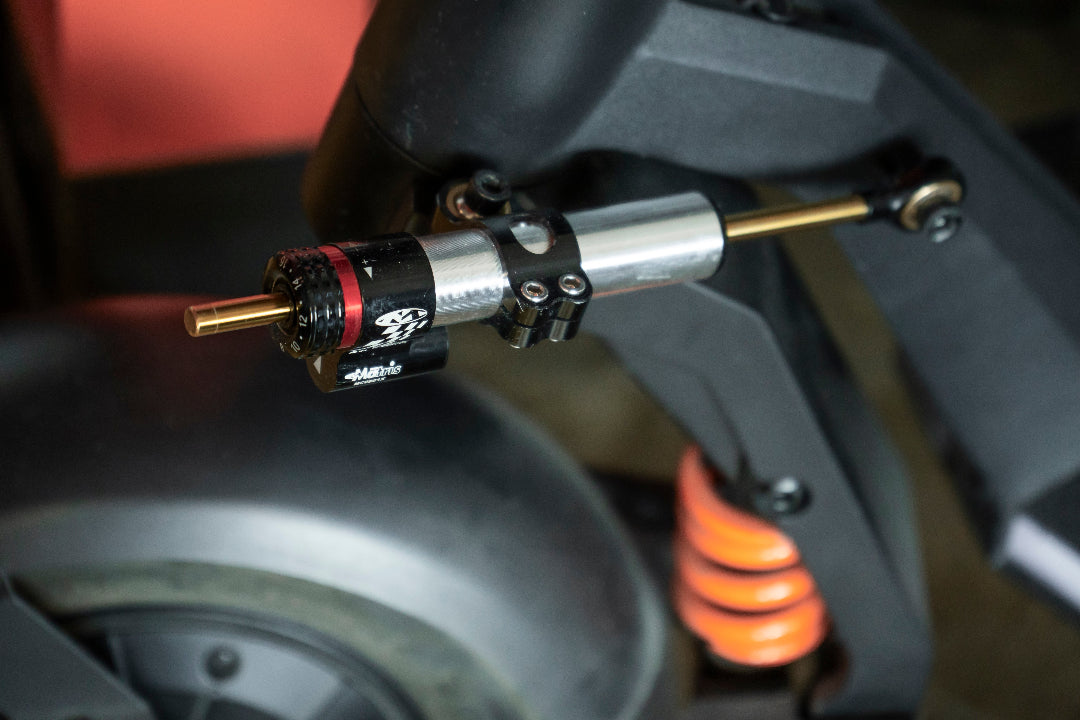Close up of a steering damper on an electric scooter