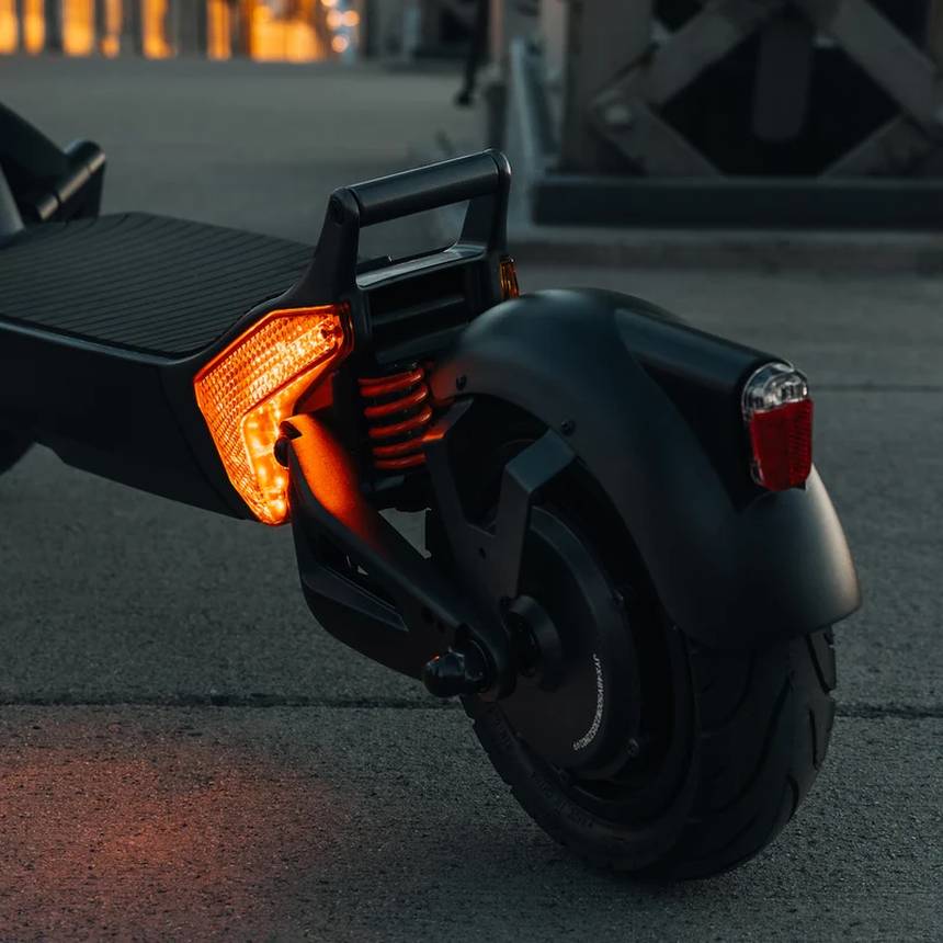 Rider on an Apollo scooter at dusk
